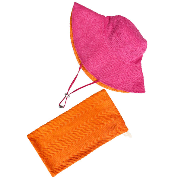 Pink side of hat shown with orange pouch. The hat features a wide brim and a chin strap, and the pouch has a patterned texture with a white zipper.