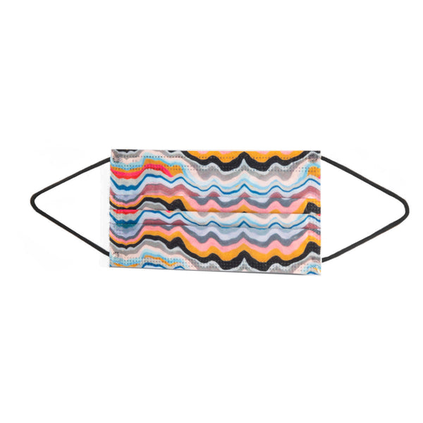 A single, patterned face mask lying flat on a white surface. The mask has a colorful design with wavy lines in various shades including pink, blue, orange, and black.