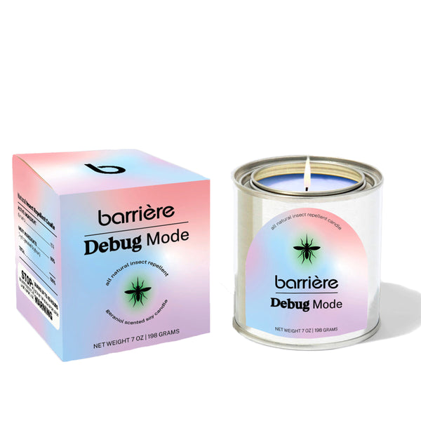 A can of "Debug Mode" scented candle by Barrière, with a soft gradient box featuring the brand logo and product name. The candle is lit, emitting a gentle flame, and sits on a white surface. The can has a sleek metallic finish, with the same logo and product name printed on it. The overall design features pastel hues of purple, pink, and blue with a subtle starburst graphic.